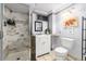 Updated bathroom with tiled shower, vanity with storage, and decorative accents at 159 Lake Rd, Idaho Springs, CO 80452
