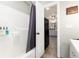 Bright bathroom with white tiled shower, modern fixtures, and a view to the kitchen at 159 Lake Rd, Idaho Springs, CO 80452
