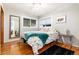 Bright bedroom with hardwood floors, two windows offering plenty of natural light and stylish decor at 159 Lake Rd, Idaho Springs, CO 80452