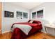 Warm and cozy bedroom features hardwood floors, two windows with views, and comfortable furnishings at 159 Lake Rd, Idaho Springs, CO 80452