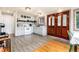 Bright kitchen with shaker cabinets, subway tile backsplash, wooden floors and an antique wooden door at 159 Lake Rd, Idaho Springs, CO 80452