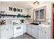 Bright kitchen with shaker cabinets, subway tile backsplash, and open shelving with views of the barn at 159 Lake Rd, Idaho Springs, CO 80452