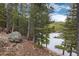 Scenic view of the lake framed by lush trees, offering a tranquil and picturesque environment at 159 Lake Rd, Idaho Springs, CO 80452