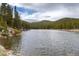 Wide lake view showcasing surrounding mountains and forests, offering a peaceful outdoor experience at 159 Lake Rd, Idaho Springs, CO 80452