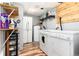 Functional laundry room with washer, dryer, storage shelves, and water heater for convenience at 159 Lake Rd, Idaho Springs, CO 80452