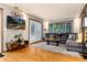Bright living room with hardwood floors, sliding doors, comfortable seating, and a wall-mounted TV at 159 Lake Rd, Idaho Springs, CO 80452
