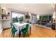 Open-concept living and dining area with wood floors, deck access, and abundant natural light at 159 Lake Rd, Idaho Springs, CO 80452