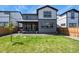 Sprawling backyard featuring a grassy lawn and patio, perfect for outdoor activities and relaxation at 27893 E 6Th Pl, Aurora, CO 80018