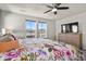 Bright bedroom featuring a floral bedspread, ceiling fan, and natural light at 27893 E 6Th Pl, Aurora, CO 80018