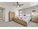 Serene bedroom with a floral bedspread, ceiling fan, and natural light, perfect for relaxation at 27893 E 6Th Pl, Aurora, CO 80018