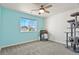 Relaxing bedroom featuring a large window, ceiling fan, neutral carpet, and decorative cat tree at 27893 E 6Th Pl, Aurora, CO 80018