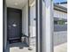 Inviting entrance with a dark-colored door, decorative wreath, and a view of the attached two-car garage at 27893 E 6Th Pl, Aurora, CO 80018