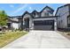 Contemporary two-story home with a gray and white exterior, a well-kept lawn, and a convenient two-car garage at 27893 E 6Th Pl, Aurora, CO 80018