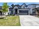 Charming two-story home featuring a modern design, well-manicured lawn, and a spacious two-car garage at 27893 E 6Th Pl, Aurora, CO 80018