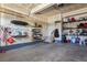 Spacious garage featuring abundant shelving and storage solutions with stairs to a back door at 27893 E 6Th Pl, Aurora, CO 80018