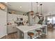 Modern kitchen featuring stainless appliances, pendant lighting, and a large island, seamlessly connected to the dining area at 27893 E 6Th Pl, Aurora, CO 80018