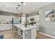 Modern kitchen featuring a large island, pendant lighting, sleek appliances, and stylish decor at 27893 E 6Th Pl, Aurora, CO 80018