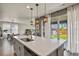 Bright, open kitchen featuring an island with sink and pendant lighting, perfect for cooking and entertaining at 27893 E 6Th Pl, Aurora, CO 80018