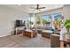 Bright living room featuring large windows, comfortable sectional sofa, and stylish decor at 27893 E 6Th Pl, Aurora, CO 80018