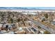 Scenic aerial view of neighborhood homes, with a snowy field and mountains in the distance at 8799 Independence Way, Arvada, CO 80005