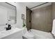 Bathroom with a shower over the tub, modern vanity, and sleek black fixtures at 8799 Independence Way, Arvada, CO 80005