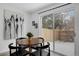 Cozy dining area featuring a round table, modern art, and sliding glass doors to the backyard at 8799 Independence Way, Arvada, CO 80005