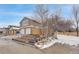 Two-story home features a two-car garage, brick accents, and landscaped front yard at 8799 Independence Way, Arvada, CO 80005