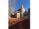 Exterior of home shows the rear elevation, with a brick chimney and a well-manicured yard at 8799 Independence Way, Arvada, CO 80005