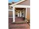 Inviting front porch with brick pavers and a charming white-framed entryway with a 