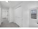 Bright hallway with closet and neutral carpet and trim at 8799 Independence Way, Arvada, CO 80005