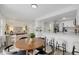 Open-concept living space featuring a kitchen with modern finishes and an adjacent dining area at 8799 Independence Way, Arvada, CO 80005