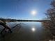 Scenic lake view reflecting the bright sun and blue sky, framed by trees at 8799 Independence Way, Arvada, CO 80005