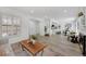 Spacious living room featuring an open floor plan, wood floors, and natural light at 8799 Independence Way, Arvada, CO 80005