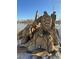 Wood sculpture featuring a turtle, eagle, and fish on a stone base at 8799 Independence Way, Arvada, CO 80005