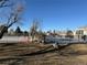 Community tennis court surrounded by fencing, located near the neighborhood pool at 8799 Independence Way, Arvada, CO 80005