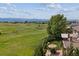 Expansive backyard with a covered patio, outdoor seating, and lush greenery at 10258 Pennington Ln, Highlands Ranch, CO 80126
