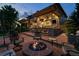 Relaxing backyard patio with a stone fireplace and outdoor seating area at 10258 Pennington Ln, Highlands Ranch, CO 80126
