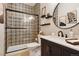 Stylish bathroom features patterned tile, glass shower, modern vanity, and round mirror at 10258 Pennington Ln, Highlands Ranch, CO 80126