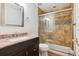 Updated bathroom with granite countertops, tiled shower, and decorative accent border at 10258 Pennington Ln, Highlands Ranch, CO 80126