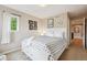 Cozy bedroom featuring a polka-dot bedspread, white furniture and a window with natural light at 10258 Pennington Ln, Highlands Ranch, CO 80126