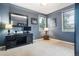Serene bedroom with neutral tones, ample natural light, and a functional workspace at 10258 Pennington Ln, Highlands Ranch, CO 80126