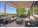 Covered patio featuring comfortable seating, a fire pit, and neighborhood views at 10258 Pennington Ln, Highlands Ranch, CO 80126