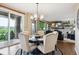 Bright dining area features modern chandelier and sliding doors to the outdoor patio at 10258 Pennington Ln, Highlands Ranch, CO 80126