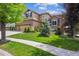 Beautiful home with a well-kept lawn and attractive landscaping, showcasing curb appeal and a three car garage at 10258 Pennington Ln, Highlands Ranch, CO 80126