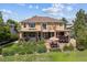 Back of home featuring a multi-level patio, well-maintained lawn, and manicured landscaping at 10258 Pennington Ln, Highlands Ranch, CO 80126
