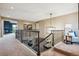 Upstairs hallway with railing overlooking game room at 10258 Pennington Ln, Highlands Ranch, CO 80126