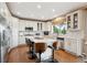 Bright kitchen features white cabinets, stainless appliances, and center island with seating at 10258 Pennington Ln, Highlands Ranch, CO 80126