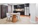 Cozy kitchenette with dark cabinets, stainless steel appliances, wine rack, table and chairs at 10258 Pennington Ln, Highlands Ranch, CO 80126