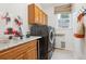 Laundry room with front load washer and dryer, granite counters and storage at 10258 Pennington Ln, Highlands Ranch, CO 80126
