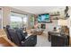 Comfortable living room with fireplace, stone accent wall, and large windows at 10258 Pennington Ln, Highlands Ranch, CO 80126